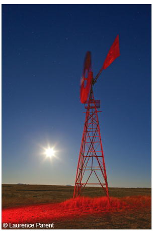 Ranch windmill on the grasslands near Marfa, with a bright full moon.